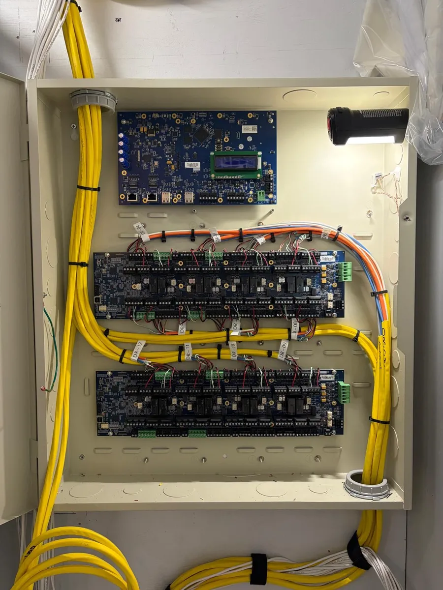 Open access control panel showing door controller boards with each door circuit labeled